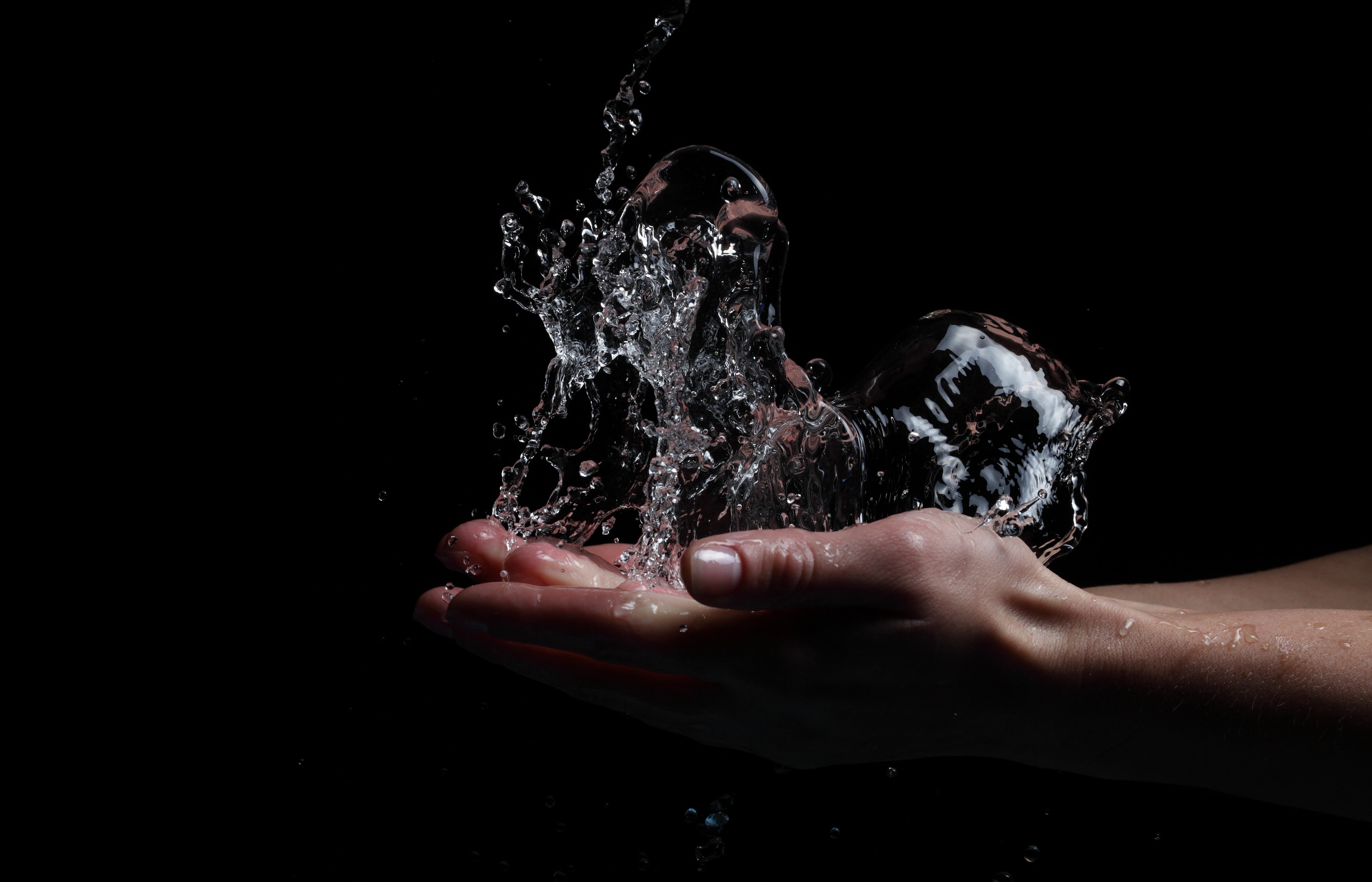 water, splashes, hands, black background, studio shot, human body part
