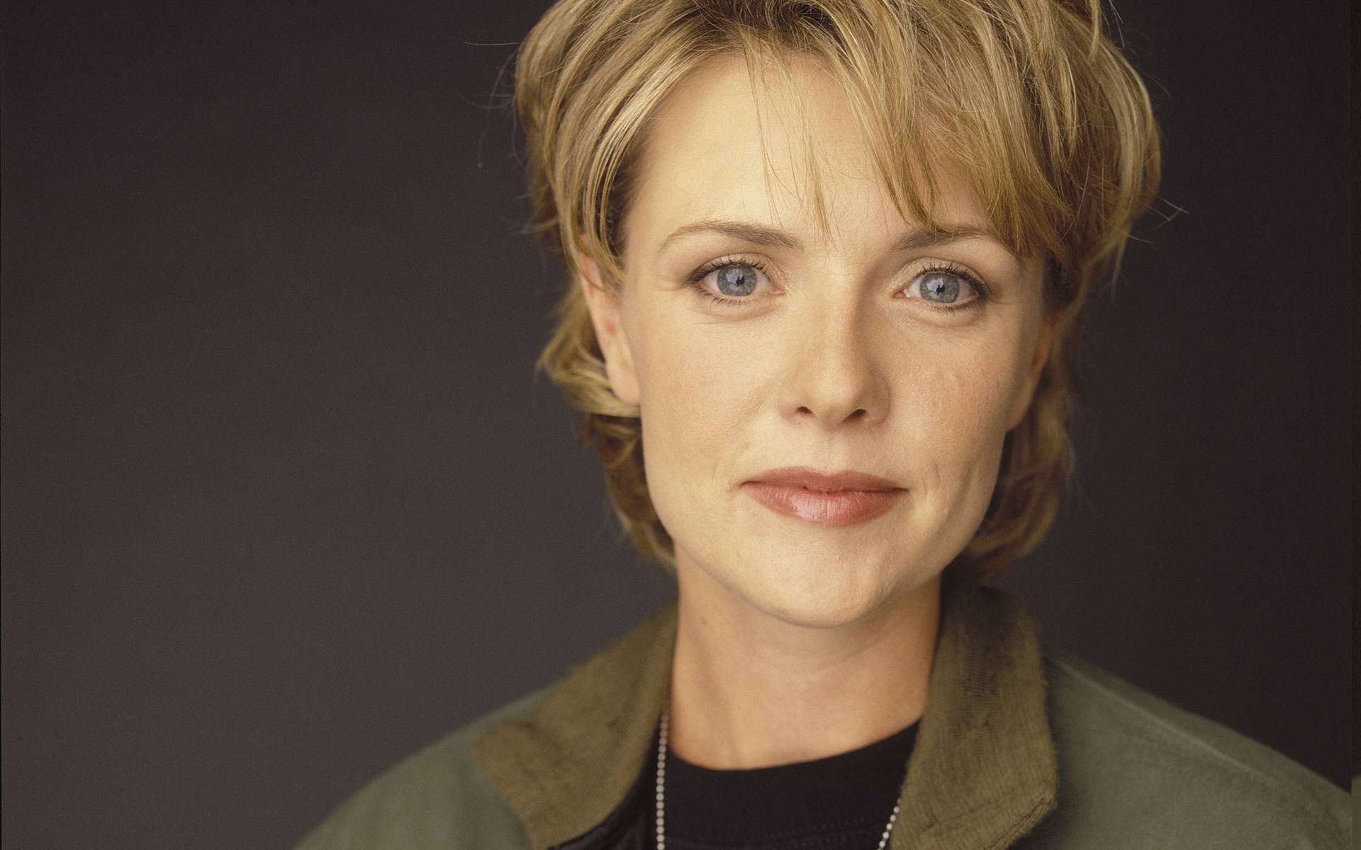 women's green collared top, amanda tapping, blonde, face, smile