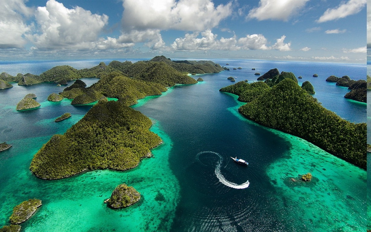 landscape nature island aerial view raja ampat indonesia tropical sea clouds summer green blue water