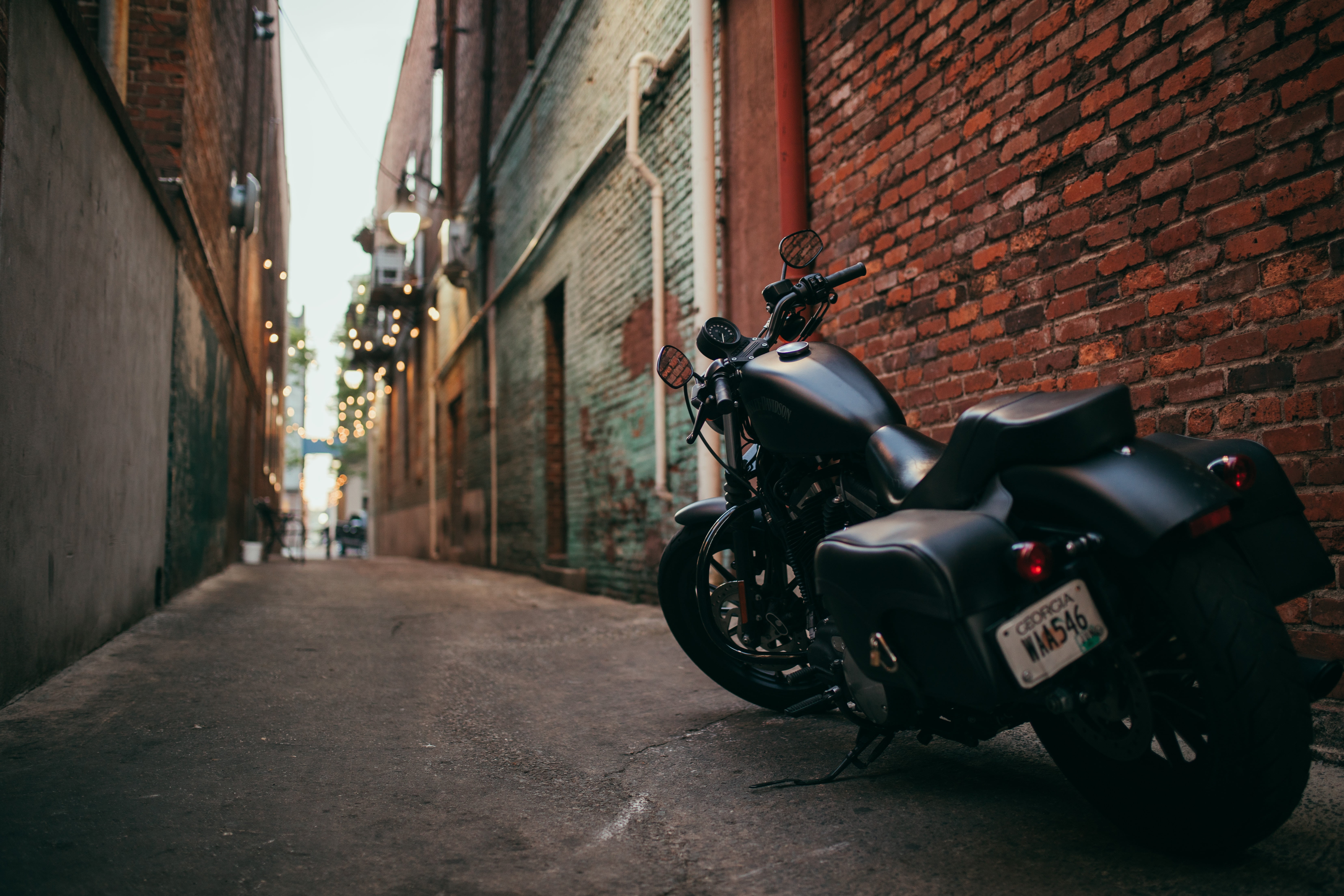 black touring motorcycle, bike, side view, yard, street, urban Scene