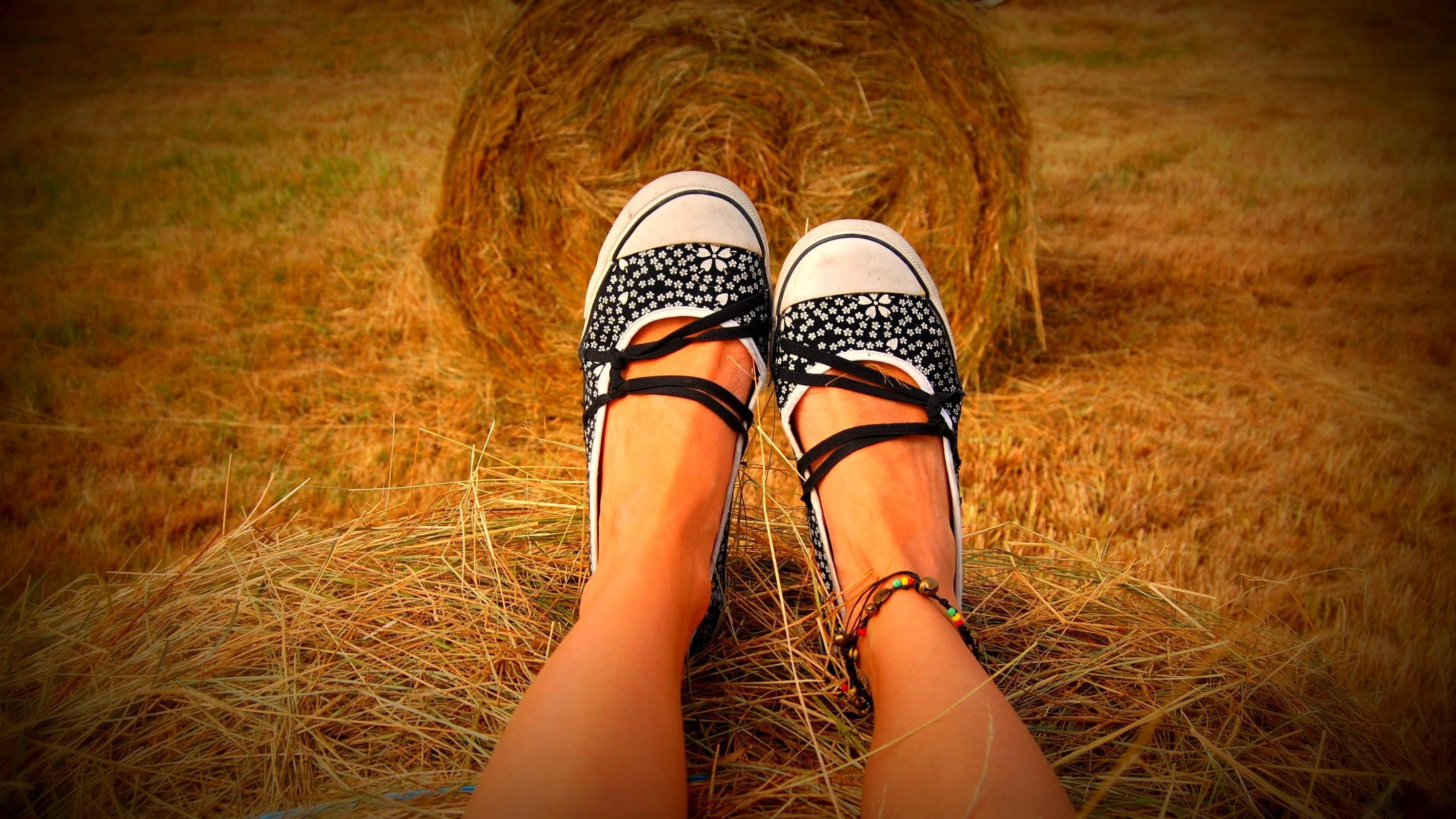 white-and-black leather flat shoes, legs, hay, grass, sit, people