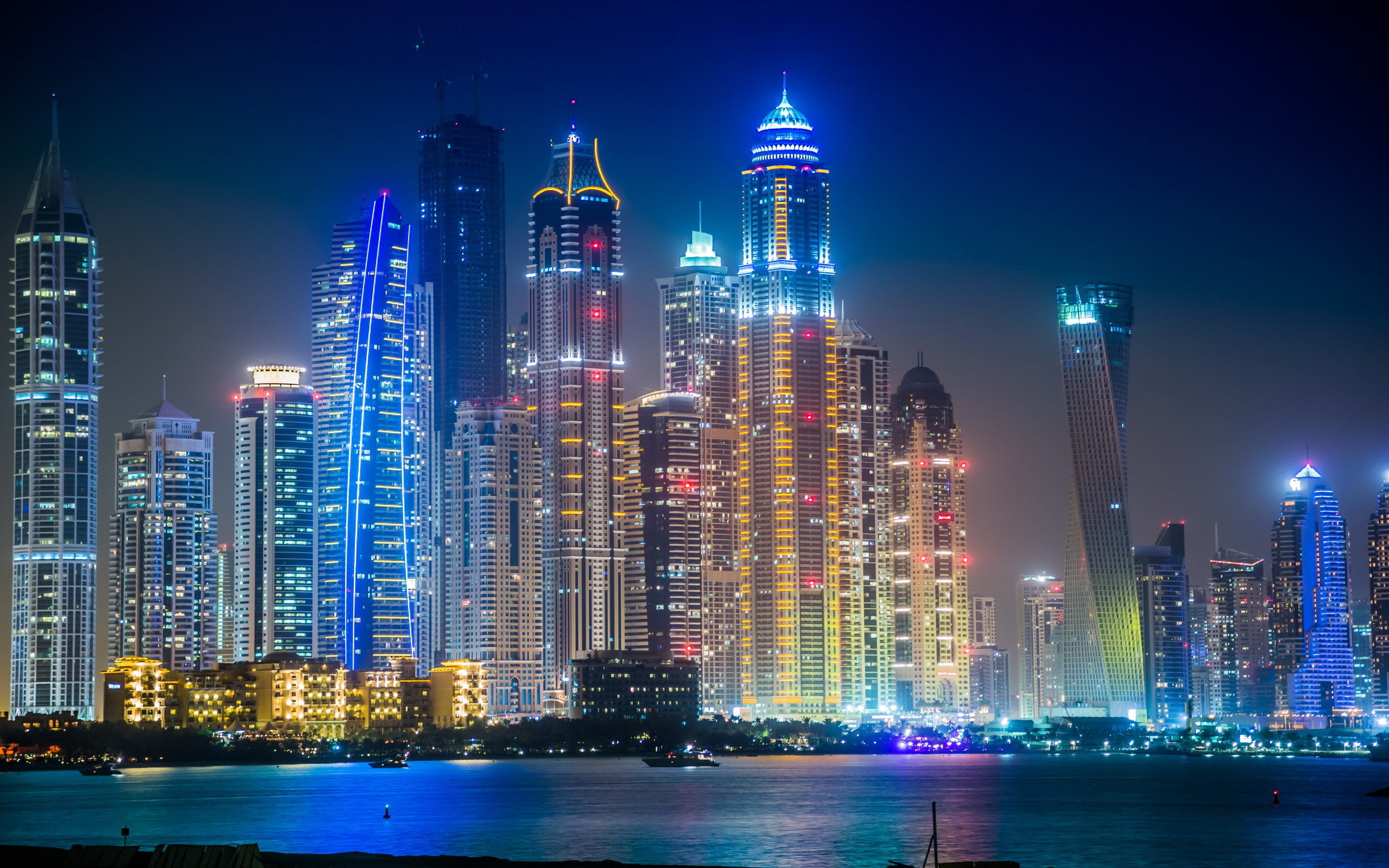 Dubai in night, skyscraper buildings