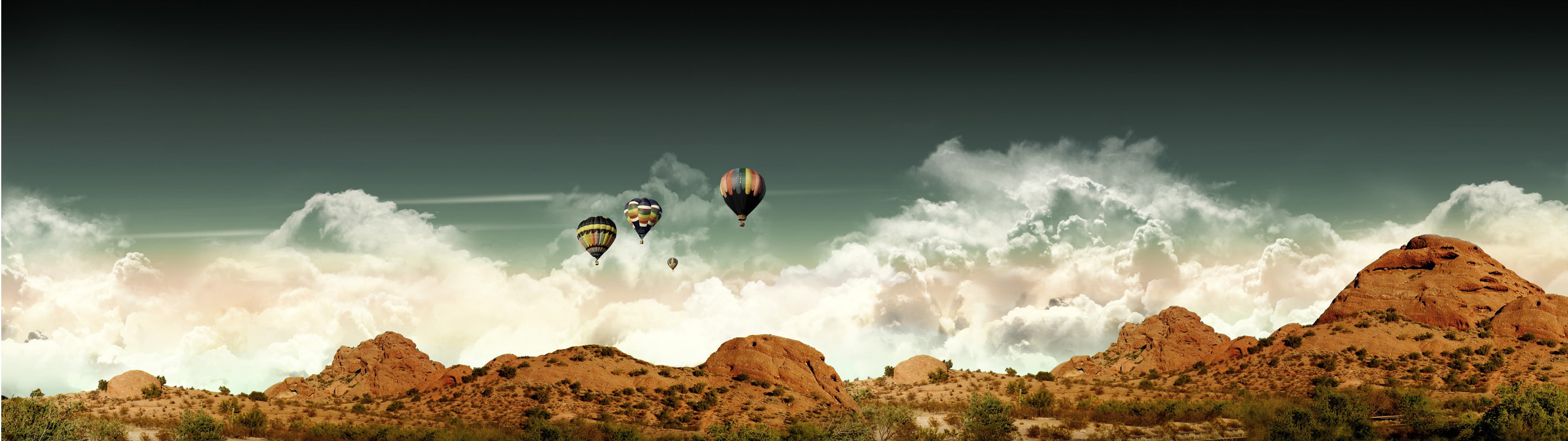 dual monitors multiple display hot air balloons mountains clouds desert landscape