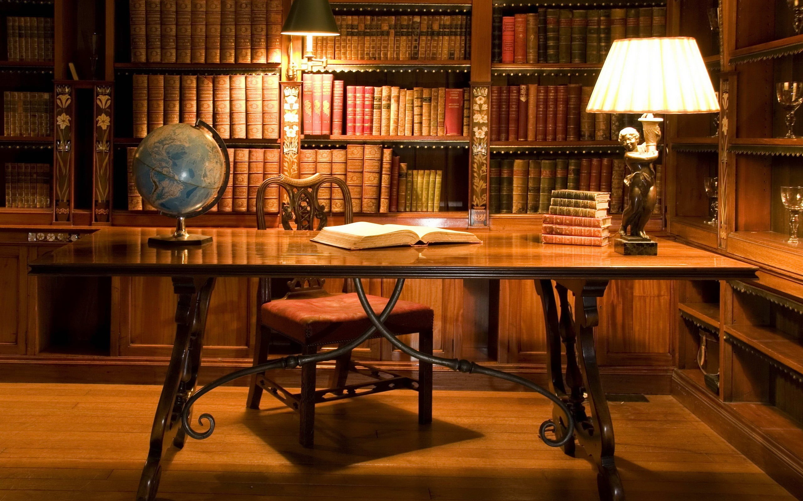 brown wooden table with chairs, books, desk, lamp, globes, indoors