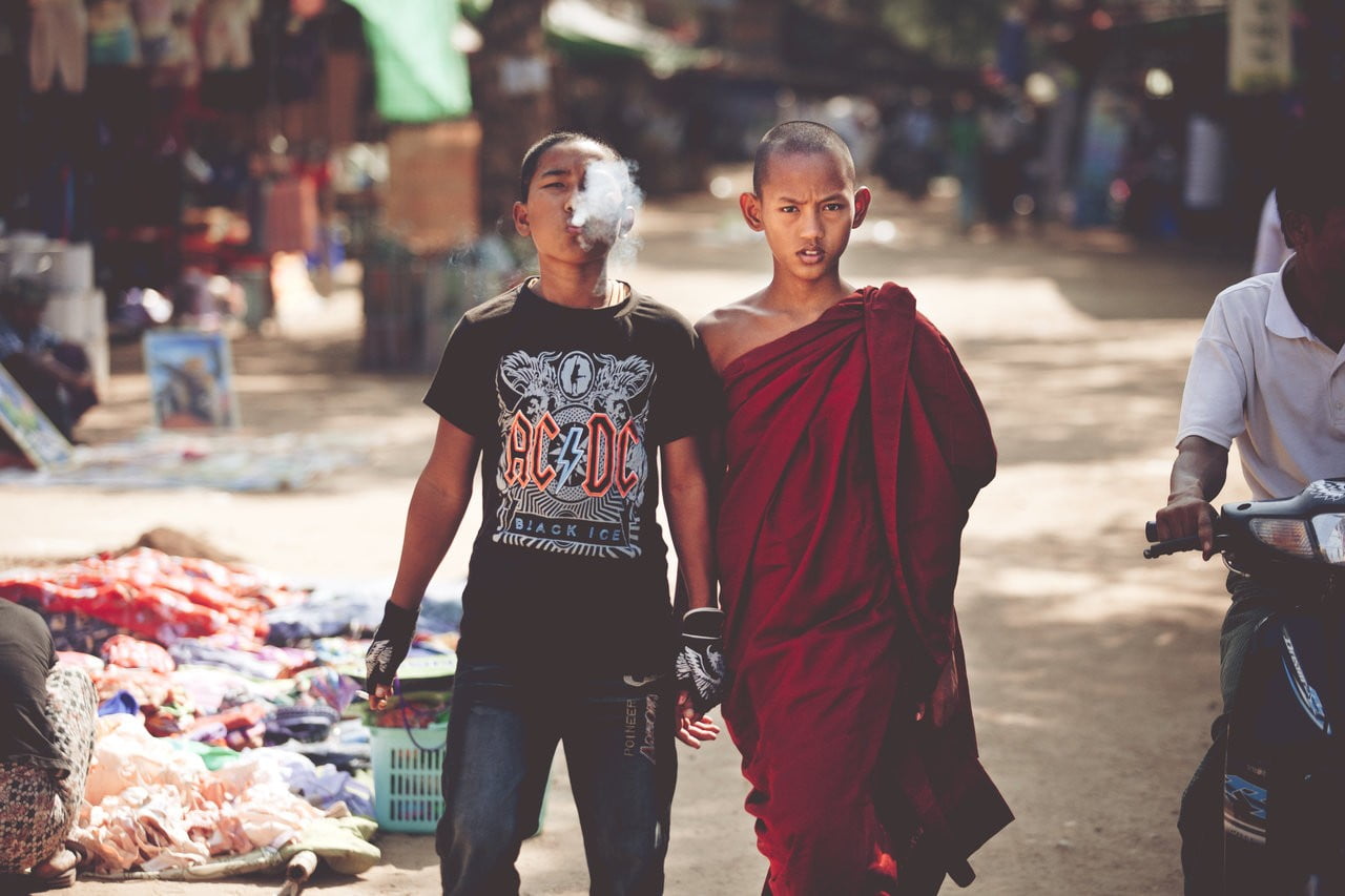 boy's red apparel, children, monks, Burma, smoking, street, Tibet