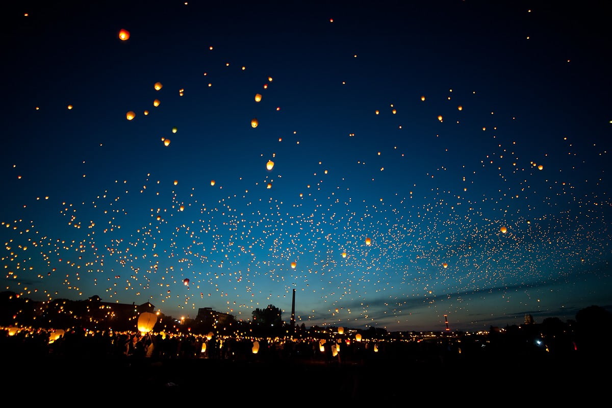 yellow sky lanterns, floating, night, glowing, evening, crowd
