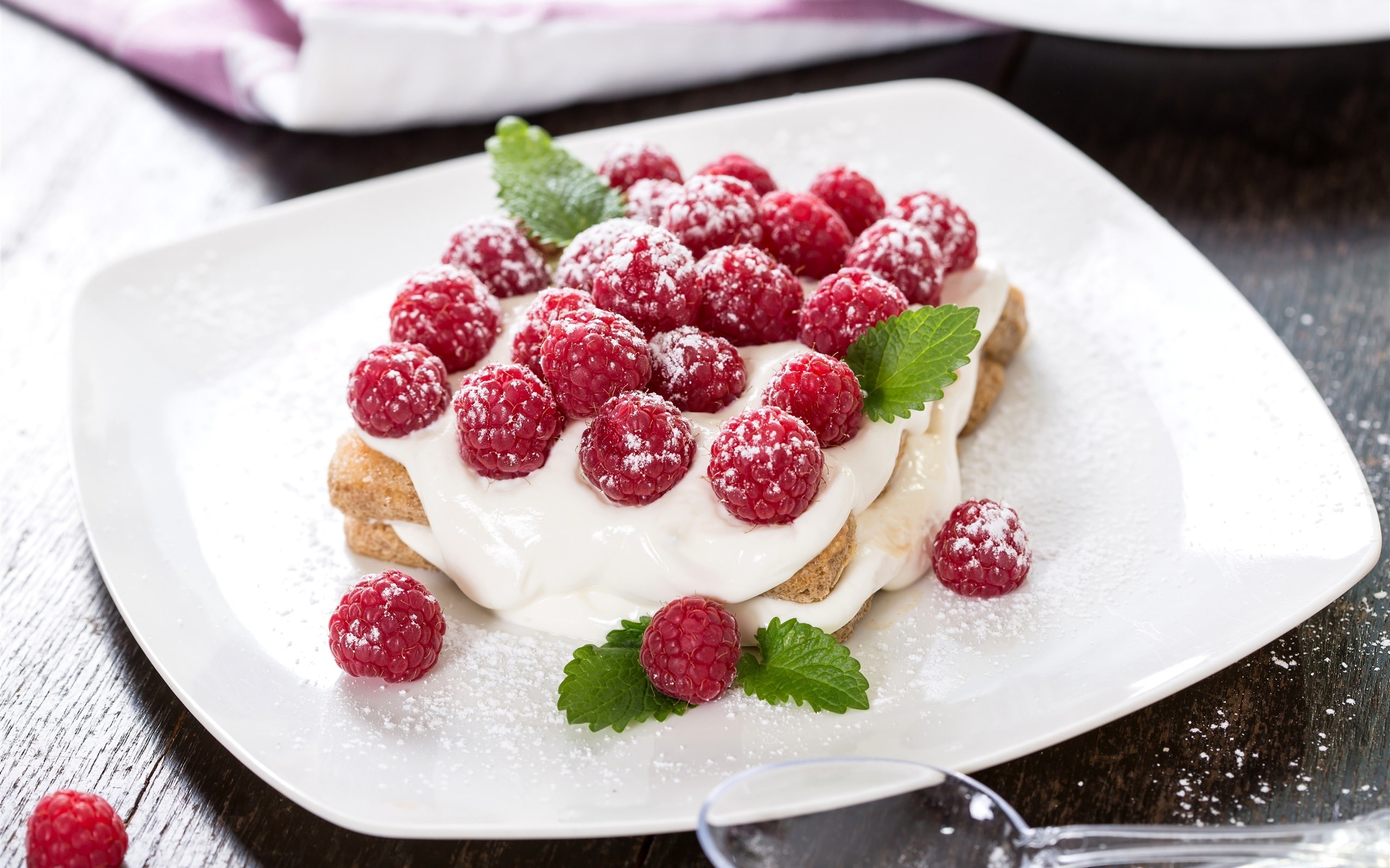 Sweet cake, cream, raspberries, red berries, bread with white cream and red fruit on top