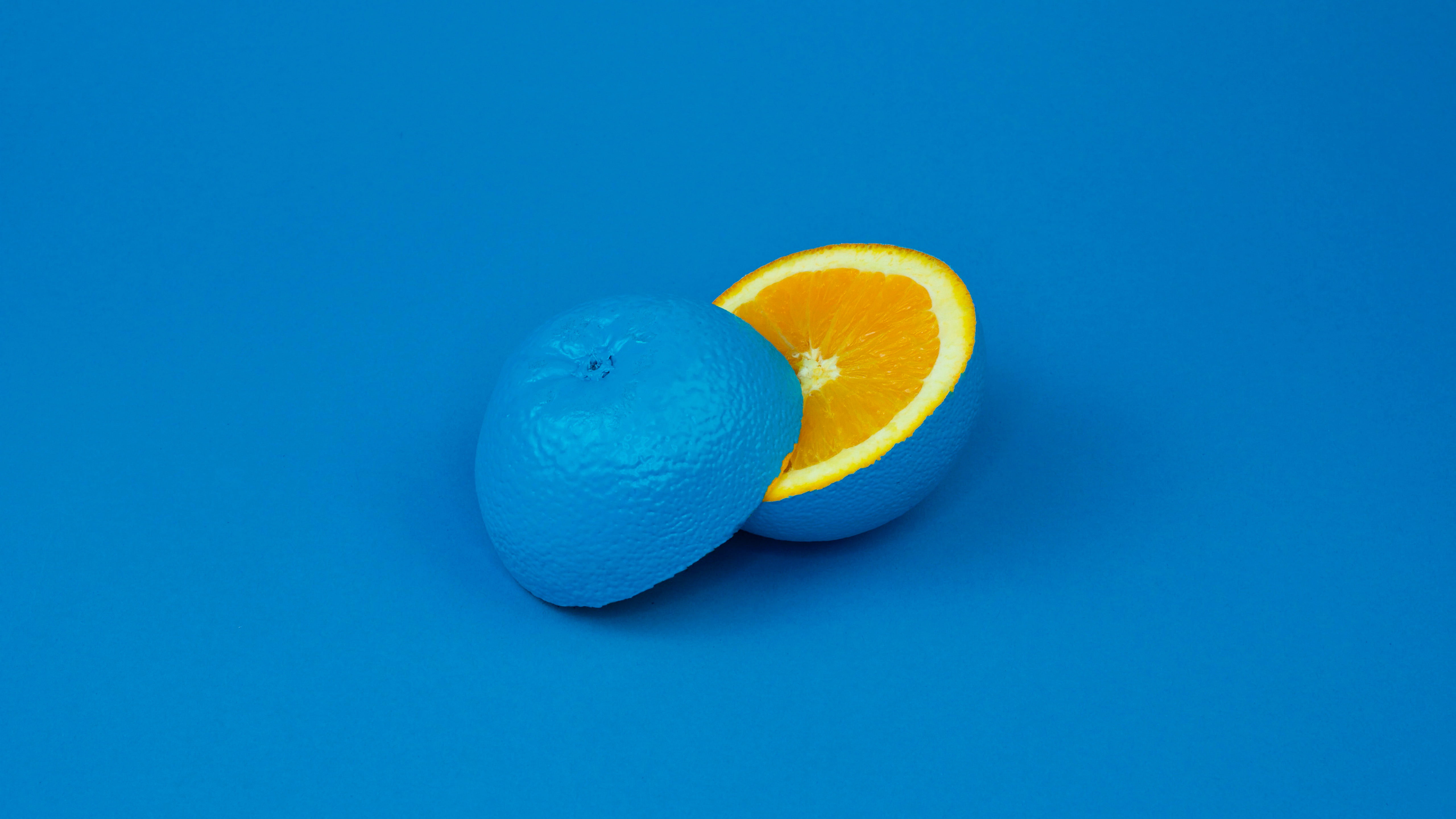 blue sliced lime, blue background, orange (fruit), yellow, studio shot