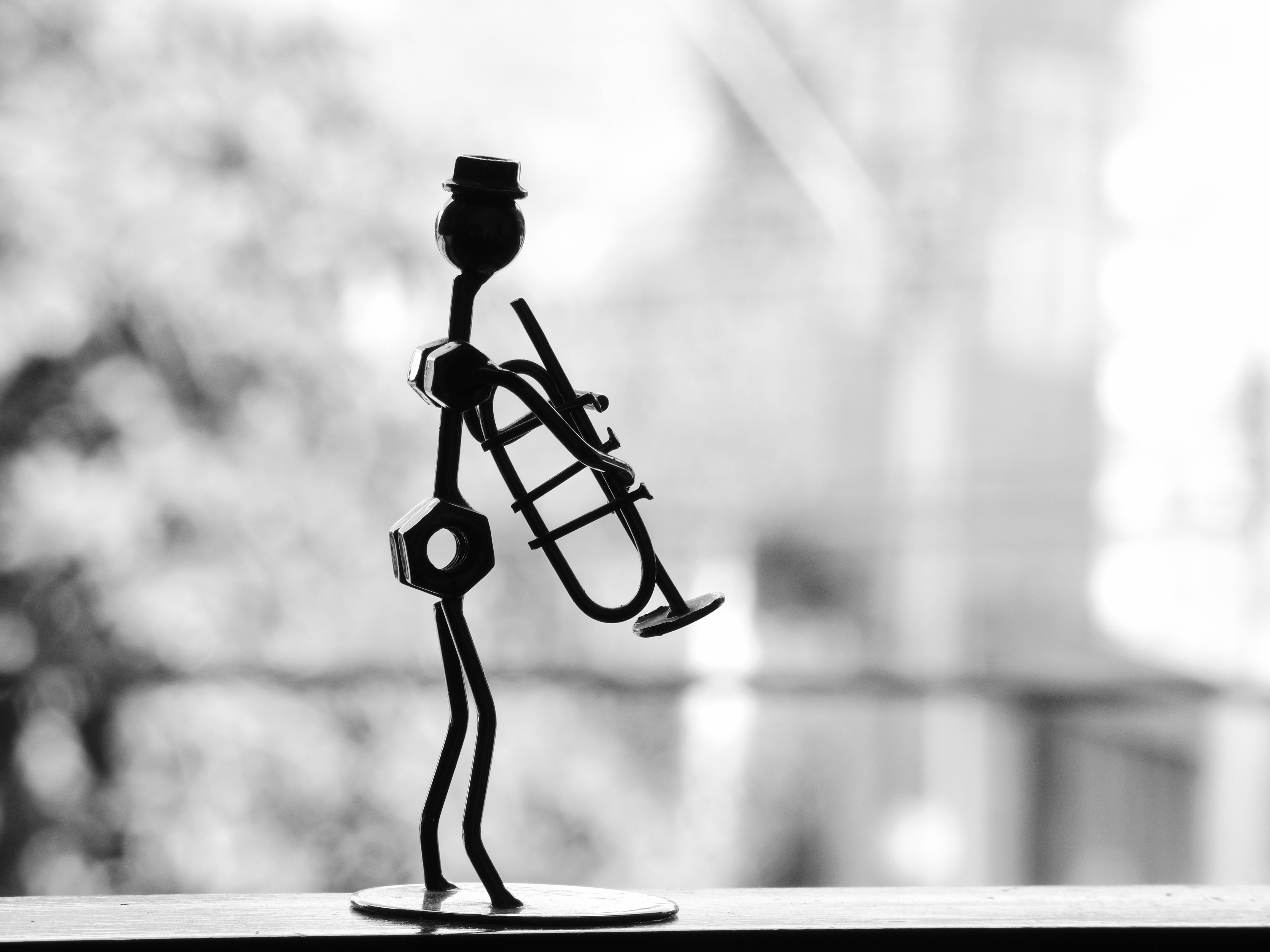 person holding trumpet scrap metal artwork, musician, pipe, statue
