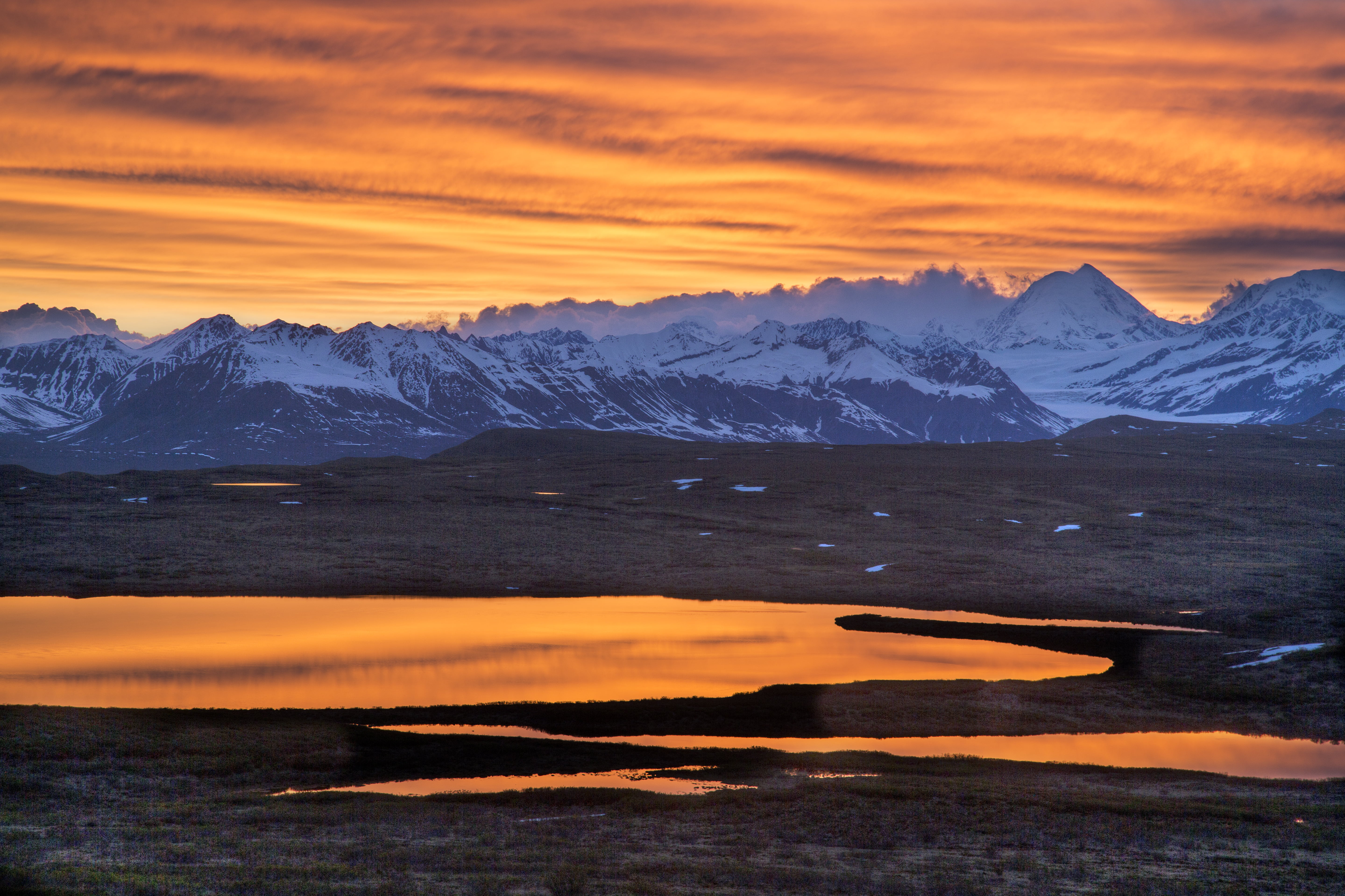 photo of mountains covered with snow under orange sky, WSR, BLM