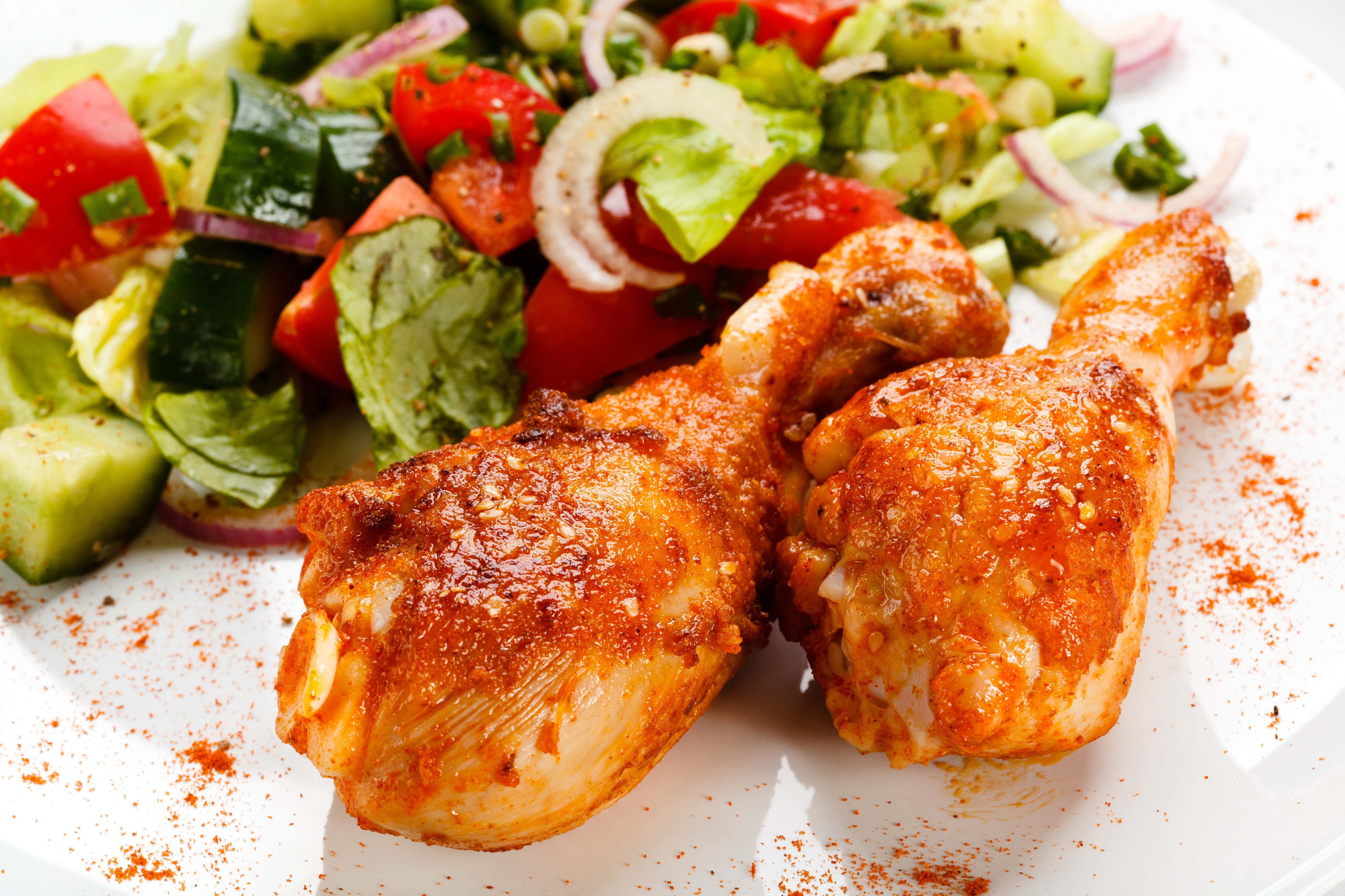 two fried chicken drumsticks, chicken legs, salad, close-up, food