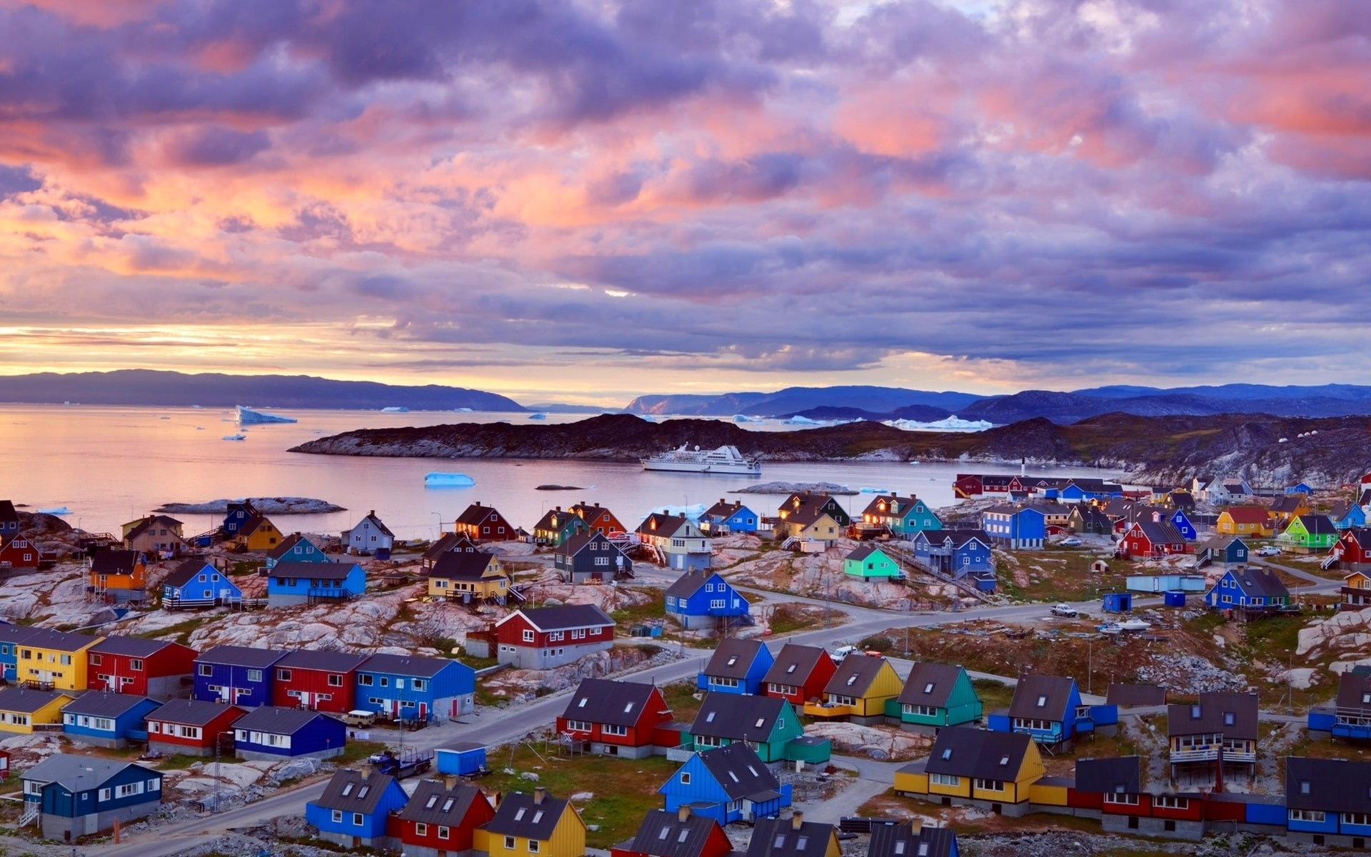 Greenland coast, colorful houses, mountains, clouds, dusk
