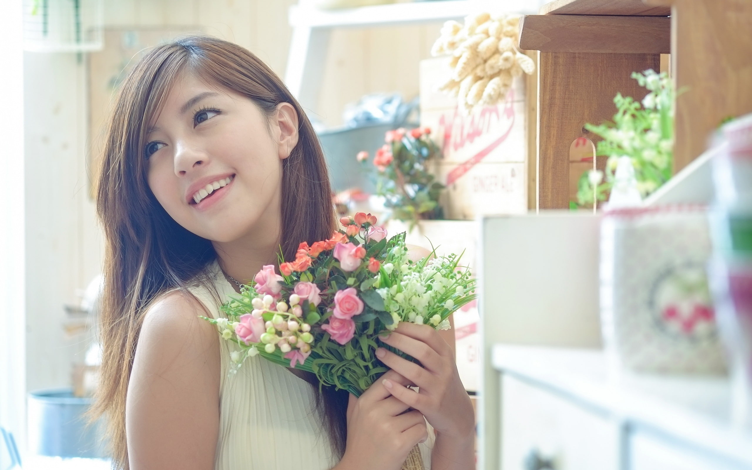 Beautiful Asian girl, holding flowers
